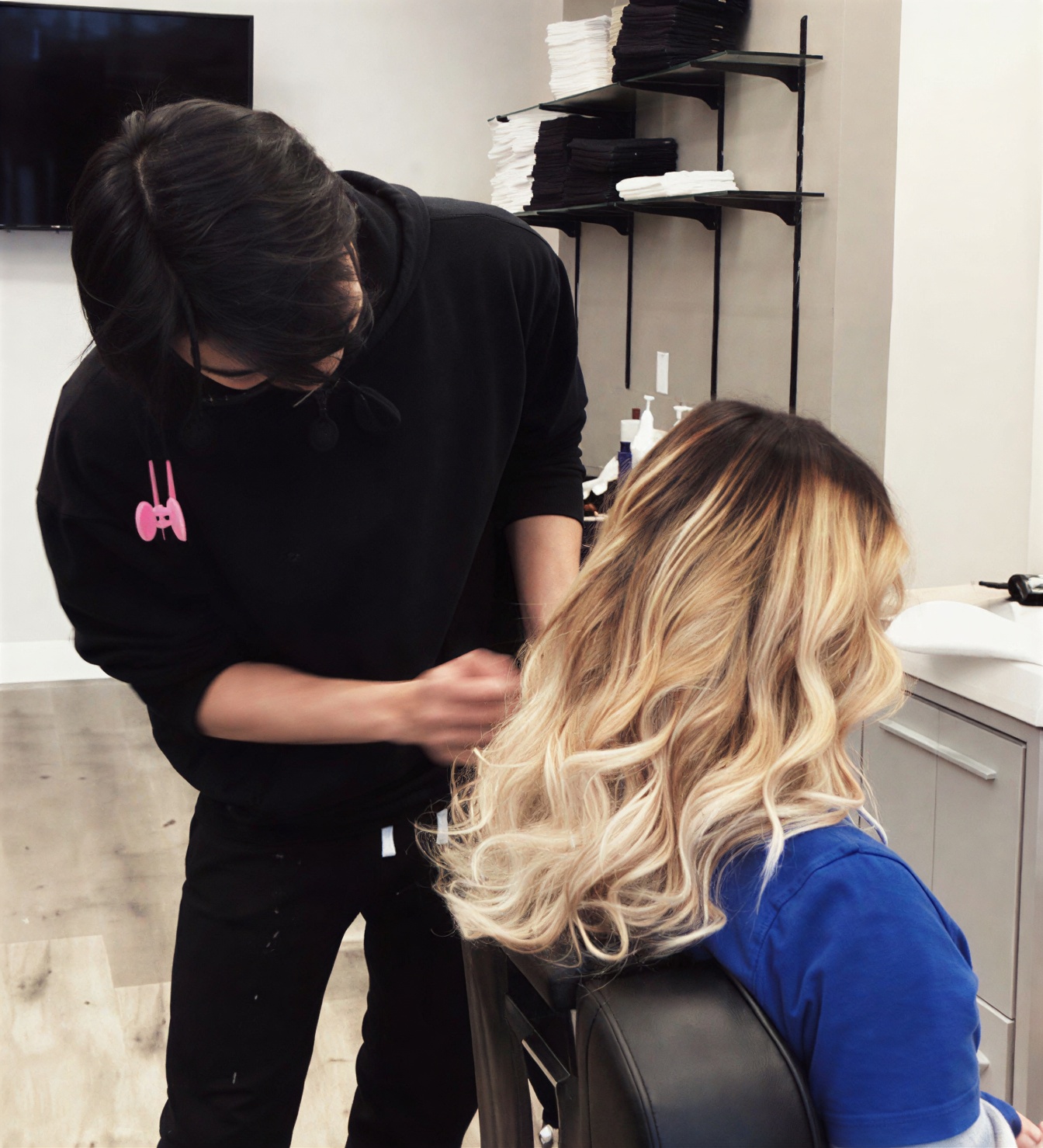 Stylist working on a blonde balayage inside N & N Hair Salon in Tsawwassen