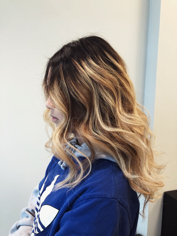 Warm blonde balayage with soft waves